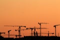 Silhouettes of tower cranes at sunset Royalty Free Stock Photo