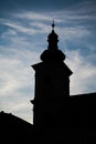 Silhouettes of towers and architectural parts with blue sky and white clouds