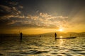 Silhouettes of the traditional fishermen throwing fishing net du