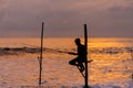 Silhouettes of the traditional Sri Lankan stilt fishermen on a stormy in Koggala, Sri Lanka. Stilt fishing is a method of fishing