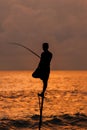 Silhouettes of the traditional Sri Lankan stilt fishermen on a stormy in Koggala, Sri Lanka. Stilt fishing is a method of fishing Royalty Free Stock Photo