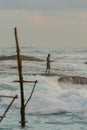 Silhouettes of the traditional Sri Lankan stilt fishermen on a stormy in Koggala, Sri Lanka. Stilt fishing is a method of fishing