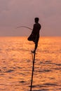 Silhouettes of the traditional Sri Lankan stilt fishermen on a stormy in Koggala, Sri Lanka. Stilt fishing is a method of fishing Royalty Free Stock Photo