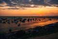 Silhouettes of Vietnamese boats in Mui Ne fishing village at sunset Royalty Free Stock Photo