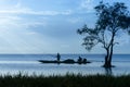 Silhouettes tree and fisherman on the boat with sunrise Royalty Free Stock Photo