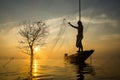 Silhouettes fisherman throwing fishing nets Royalty Free Stock Photo