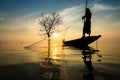Silhouettes fisherman throwing fishing nets Royalty Free Stock Photo