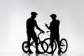 silhouettes of trial bikers with bicycles chatting