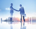 Silhouettes of Two Businessmen Having a Handshake Royalty Free Stock Photo