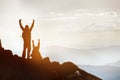 Two happy silhouettes tourists at mountain top success win Royalty Free Stock Photo