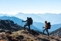 Silhouettes of two Hikers in front of Morning Mountains View Royalty Free Stock Photo