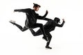 The silhouettes of two hip hop male and female break dancers dancing on white background