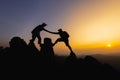 Silhouettes of two people climbing on mountain and helping. Teamwork of two men hiker helping each other on top of mountain Royalty Free Stock Photo