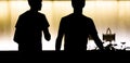 Silhouettes of two teen boys walking in the summer night