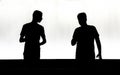 Silhouettes of two teenage boys in the night