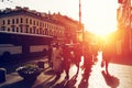 Silhouettes of unrecognizable people in street of Saint Petersburg in sunset sunlight