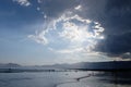 Silhouettes of unrecognizable People walking jumping on beach at sunset, enjoying free time. Beautiful cloudy sky over Royalty Free Stock Photo