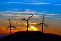 Silhouettes Of Wind Turbines At Sunset