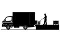 Silhouettes of worker loading small truck. Royalty Free Stock Photo