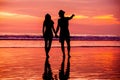 Silhouettes of young couple in love staing on the