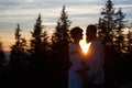 Silhouettes of young couple in love at sunset Royalty Free Stock Photo
