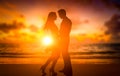 silhouettes of young couple of lovers at sunset on the beach. romance, relationships, love. Holiday romance, honeymoon Royalty Free Stock Photo