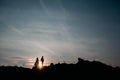 Silhouettes of a young couple lovers at sunset on dramatic sky background. Place for text or advertising Royalty Free Stock Photo