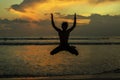 silhouettes of young jumping boy at famous sunset beach in Kuta, Bali, Indonesia Royalty Free Stock Photo