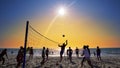 Silhouettes of young men playing volleyball on Varkala beach at sunset Royalty Free Stock Photo