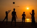 Silhouettes a young people on a beach Royalty Free Stock Photo