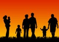 Silhouettes of young people with children Royalty Free Stock Photo