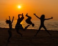 Silhouettes a young people having fun on a beach Royalty Free Stock Photo