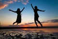 Silhouettes of young people jumping with excitement Royalty Free Stock Photo