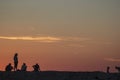 Silhouettes of of young people at sea jetty