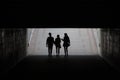 Silhouettes of young people in the underpass