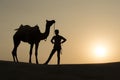 Silhoutte of Camel Boy crossing in the Thar Desert. Royalty Free Stock Photo