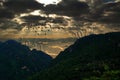 Silhoutte of flock of birds fly over the mountains on the background of the sunrise