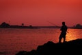 Silhoutte of a man fishing