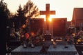 Silhuette of a cross grave against evening sun in cemetery Royalty Free Stock Photo