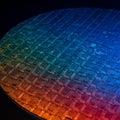 Silicon wafer featuring a grid of microchips under a gradient light. The surface is Royalty Free Stock Photo