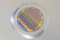 Silicon wafer with microchips fixed in the holder with steel frame on the grey background and ready for process