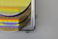 Silicon Wafers in steel holder box on a table- A wafer is a thin slice of semiconductor material, such as a crystalline silicon,