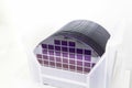 Silicon Wafers in white plastic holder box on a table- A wafer is a thin slice of semiconductor material, such as a