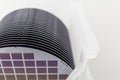 Silicon Wafers in white plastic holder box on a table- A wafer is a thin slice of semiconductor material, such as a