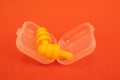 Silicone ear plugs for human ears on red background Royalty Free Stock Photo