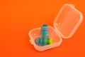 Silicone ear plugs for human ears on red background Royalty Free Stock Photo