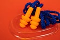 Silicone ear plugs for human ears on red background Royalty Free Stock Photo