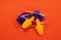 Silicone ear plugs for human ears on red background Royalty Free Stock Photo