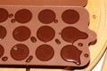 Silicone molds for shaping chocolate and sweets are filled with hot chocolate to cool Royalty Free Stock Photo