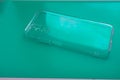 Silicone protective case for smartphone on turquoise blue background Royalty Free Stock Photo